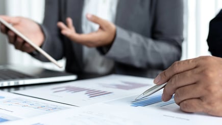 Business professionals reviewing financial charts and graphs during a meeting